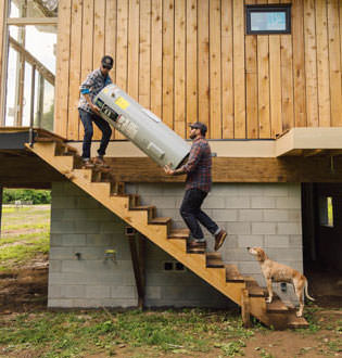 Carrying water heater up the stairs photo